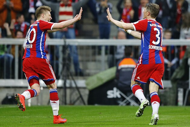 Bayern's Bastian Schweinsteiger, right, celebrates with teammate Mitchell Weiser after scoring his side's opening goal during the German first division Bundesliga soccer match between FC Bayern Munich and Hertha BSC at the Allianz Arena in Munich, Germany, on Saturday, April 25, 2015. (AP Photo/Matthias Schrader)