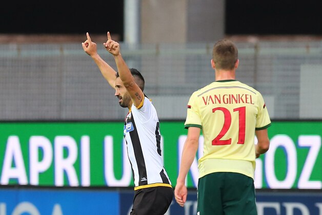 Udinese's Giampiero Pinzi, left, celebrates after scoring during a Serie A soccer match between Udinese and Milan at the Friuli Stadium in Udine, Italy, Saturday, April 25, 2015. (AP Photo/Paolo Giovannini)