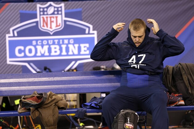 Iowa offensive lineman Brandon Scherff puts on his sweatshirt after pulling up while running a drill at the NFL football scouting combine in Indianapolis, Friday, Feb. 20, 2015. (AP Photo/David J. Phillip)