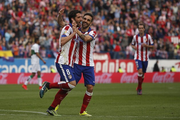 Atletico's Raul Garcia, left, celebrates his goal with Atletico's Jesus Gamez during a Spanish La Liga soccer match between Atletico Madrid and Elche at the Vicente Calderon stadium in Madrid, Spain, Saturday, April 25, 2015. (AP Photo/Andres Kudacki)