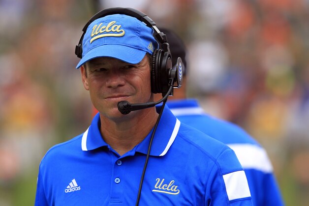 UCLA head coach Jim Mora watches from the sidelines during the first half of an NCAA college football game against Virginia at Scott Stadium, Saturday, Aug. 30, 2014, in Charlottesville, Va. (AP Photo/Andrew Shurtleff)