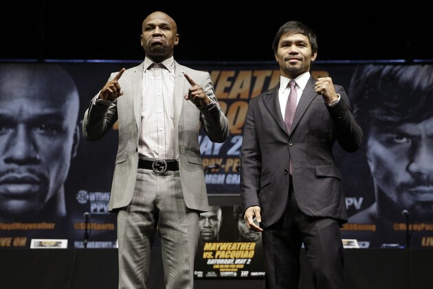 ADVANCE FOR WEEKEND EDITIONS, APRIL 25-26 - FILE - In this March 11, 2015, file photo, boxers Floyd Mayweather Jr., left, and Manny Pacquiao, of the Philippines, pose for photos after a news conference in Los Angeles. This is not Hagler-Hearns or Tyson vs. Anyone. Floyd Mayweather Jr. is the greatest defensive boxer in history, and Manny Pacquiao hasn't shown knockout power in a while. Expect this fight to go to the scorecards. (AP Photo/Jae C. Hong, File)