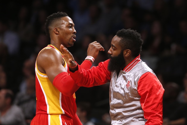Houston Rockets' Dwight Howard, left, celebrates with teammate James Harden during the second quarter of an NBA basketball game against the Brooklyn Nets Monday, Jan. 12, 2015, in New York.  Houston beat Brooklyn 113-99. (AP Photo/Jason DeCrow)