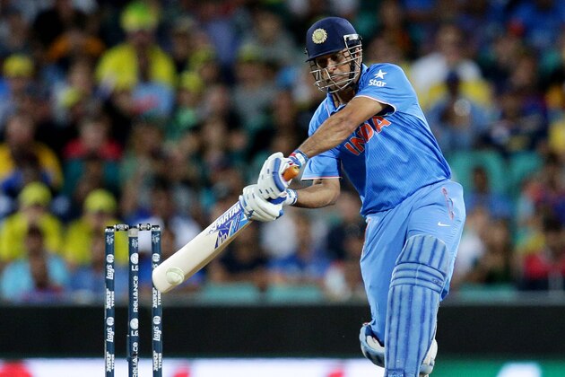 India's MS Dhoni hits the ball for six runs while batting against Australia during their Cricket World Cup semifinal in Sydney, Australia, Thursday, March 26, 2015. (AP Photo/Rob Griffith)