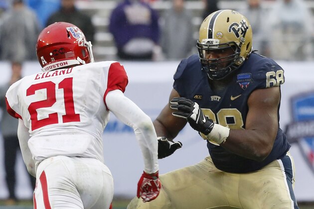 Houston defensive end Eric Eiland (21) and Pittsburgh offensive lineman T.J. Clemmings (68) during the second half of the Armed Forces Bowl NCAA college football game, Friday, Jan. 2, 2015, in Fort Worth. Texas. Houston won 35-34. (AP Photo/Sharon Ellman)