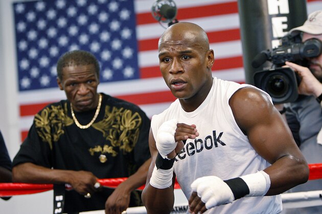 FILE - In this Sept. 19, 2009, file photo, boxier Floyd Mayweather Jr., right, works out at his gym as his father, Floyd Mayweather Sr., left, looks on in Las Vegas. He taught his son to throw punches before he could walk, and he'll be in his corner for the biggest fight of his life against Manny Pacquiao on May 2. The relationship betwee Mayweather Sr. and his son, though, hasn't always been good. (AP Photo/Isaac Brekken, File0