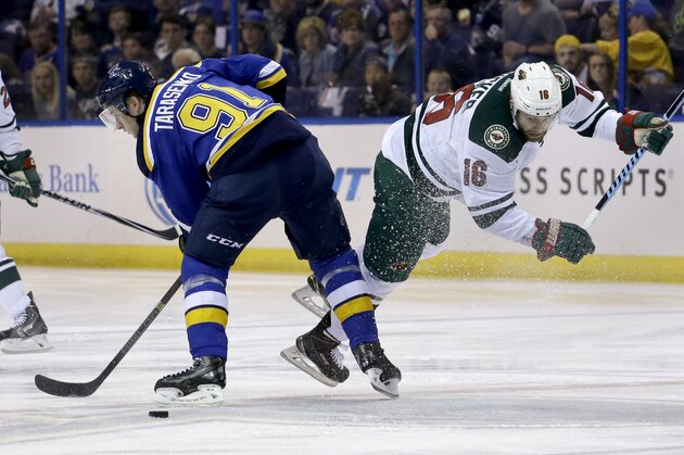 Minnesota Wild's Jason Zucker, right, is tripped up by St. Louis Blues' Vladimir Tarasenko, of Russia, during the first period in the first round of the NHL hockey Stanley Cup playoffs, Saturday, April 18, 2015, in St. Louis. (AP Photo/Jeff Roberson)