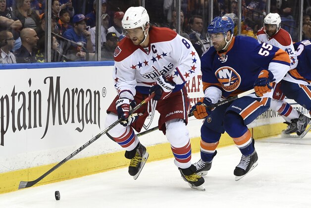 Washington Capitals left wing Alex Ovechkin (8) tries to control the puck against New York Islanders defenseman Johnny Boychuk (55) during the third period in Game 6 in the first round of the NHL hockey Stanley Cup playoffs at Nassau Coliseum on Saturday, April 25, 2015, in Uniondale, N.Y. The best-of-seven games series is tied 3-3. (AP Photo/Kathy Kmonicek)