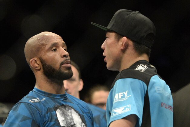 Apr 25, 2015; Montreal, Quebec, CAN; Demetrious Johnson (red) and Kyoji Horiguchi (blue) congratulate each other after their fight during their flyweight bout during UFC 186 at Bell Centre. Mandatory Credit: Eric Bolte-USA TODAY Sports