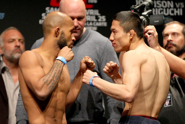 Apr 24, 2015; Montreal, Quebec, CAN; Demetrious Johnson and Kyoji Horiguchi pose during weigh-ins for UFC 186 at Metropolis. Mandatory Credit: Jean-Yves Ahern-USA TODAY Sports