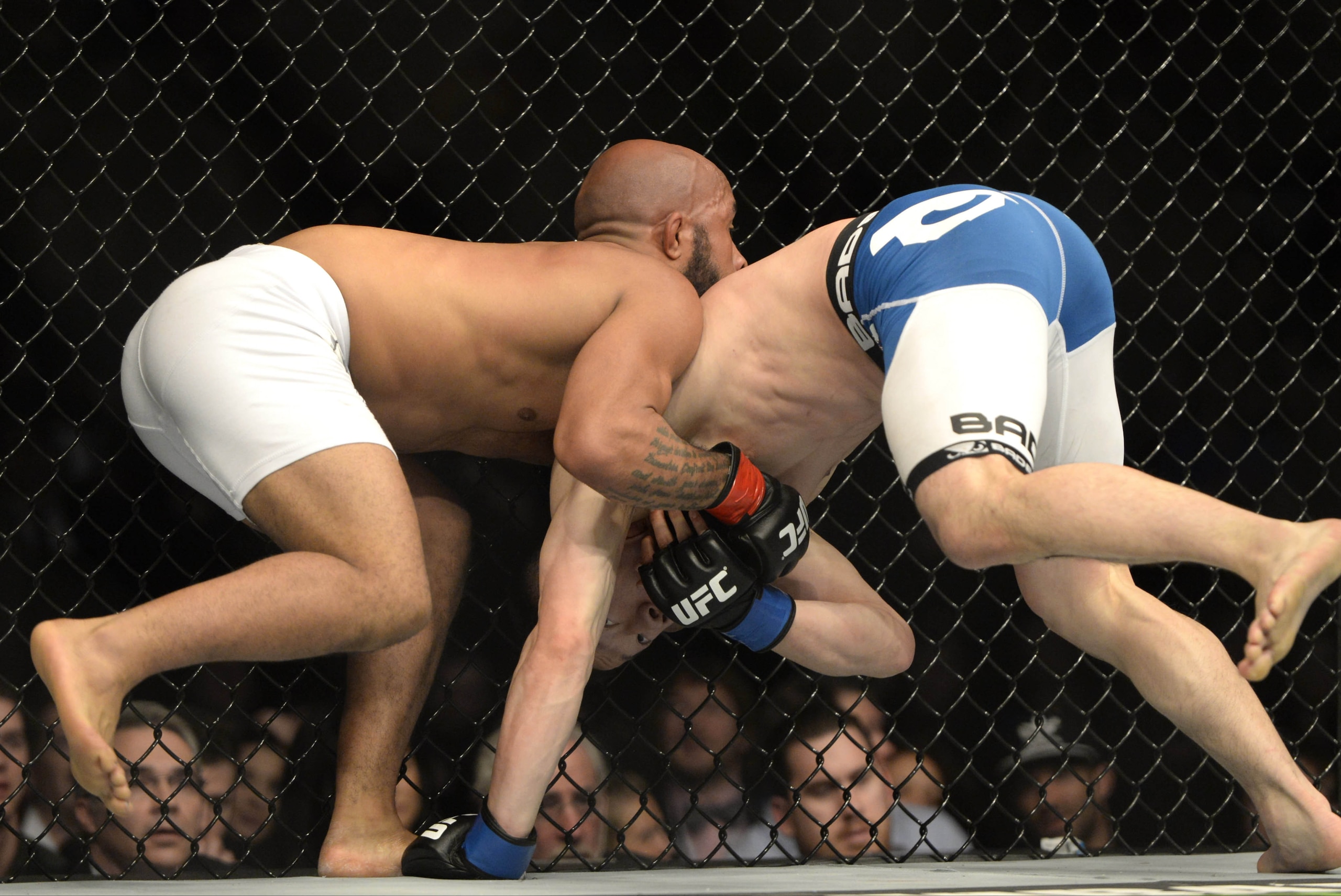 Apr 25, 2015; Montreal, Quebec, CAN; Demetrious Johnson (red) and Kyoji Horiguchi (blue) fight during their flyweight bout during UFC 186 at Bell Centre. Mandatory Credit: Eric Bolte-USA TODAY Sports