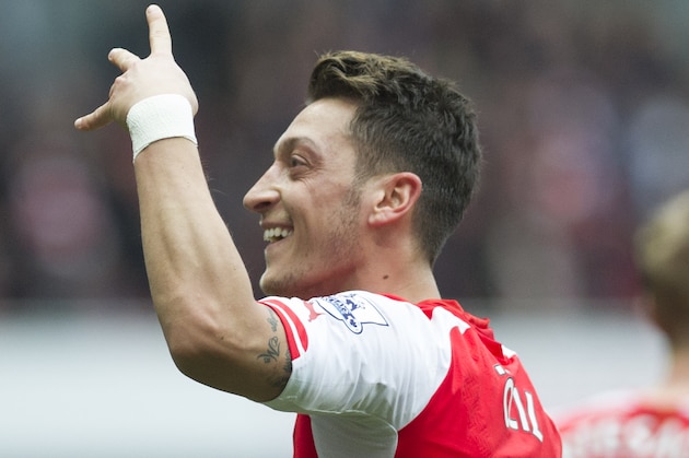 Arsenal's Mesut Özil celebrates after scoring against Liverpool during their English Premier League soccer match, at Emirates Stadium, in London, Saturday, April 4, 2015. (AP Photo/Bogdan Maran)
