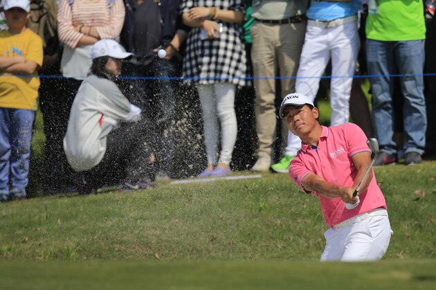 Wu Ashun of China hits from a bunker on the 8th hole during the final round of the Volvo China Open in Shanghai, China, Sunday, April 26, 2015. (AP Photo)