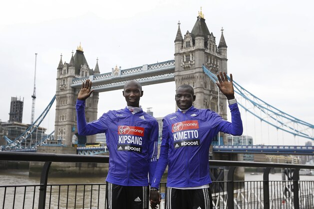 Elite Kenyan athletes Wilson Kipsang, left, and Dennis Kimetto, right, who will compete in the London Marathon, pose for the media near Tower Bridge in London, Thursday, April 23, 2015. Kipsang and Kimetto, both marathon world record breakers will compete head-to-head for the first time in the 35th London Marathon which will take place on Sunday April 26. (AP Photo/Kirsty Wigglesworth)