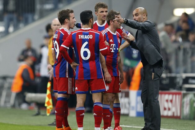 Bayern's head coach Pep Guardiola, right, instructs his players during the soccer Champions League quarterfinal second leg match between Bayern Munich and FC Porto at the Allianz Arena in Munich, southern Germany, Tuesday, April 21, 2015. (AP Photo/Michael Probst)