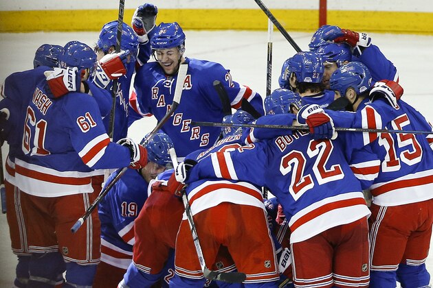 The New York Rangers celebrate after beating the Pittsburgh Penguins 2-1 in overtime of Game 5 in the first round of the NHL hockey Stanley Cup playoffs, Friday, April 24, 2015, in New York. (AP Photo/Julie Jacobson)
