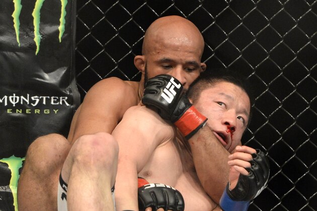 Apr 25, 2015; Montreal, Quebec, CAN; Demetrious Johnson (red) and Kyoji Horiguchi (blue) fight during their flyweight bout during UFC 186 at Bell Centre. Mandatory Credit: Eric Bolte-USA TODAY Sports