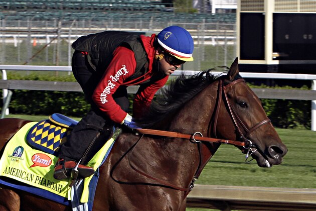 Exercise rider Jorge Alvarez gallops Kentucky Derby hopeful American Pharoah at Churchill Downs in Louisville, Ky., Thursday, April 23, 2015.  (AP Photo/Garry Jones)