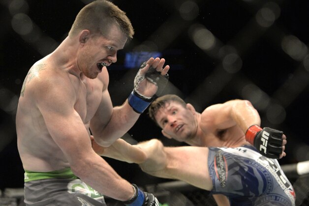 Apr 25, 2015; Montreal, Quebec, CAN; Michael Bisping (red) and CB Dalloway (blue) fight during their middleweight bout during UFC 186 at Bell Centre. Mandatory Credit: Eric Bolte-USA TODAY Sports
