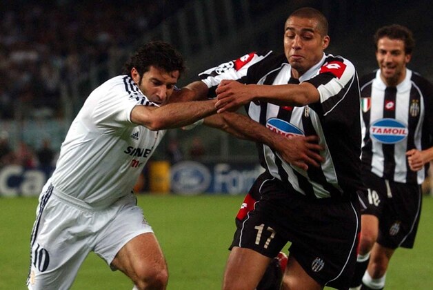 Juventus forward David Trezeguet of France , right, challenges for the ball with  Real Madrid's  Luis Figo of Portugal during the Champions League second leg semifinal soccer match at the Delle Alpi stadium in Turin, Italy, Wednesday, May 14, 2003. On the right Juventus Alessandro Del Piero .(AP Photo/Luca Bruno)