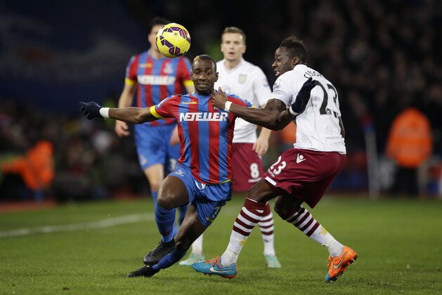 Crystal Palace's Yannick Bolasie, left, competes for the ball with Aston Villa's Aly Cissokho during the English Premier League soccer match between Crystal Palace and Aston Villa at Selhurst Park stadium in London, Tuesday, Dec. 2, 2014.  (AP Photo/Matt Dunham)
