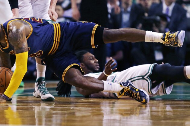 Cleveland Cavaliers forward LeBron James hits the floor after colliding with Boston Celtics forward Jae Crowder during the second quarter of a first-round NBA playoff basketball game in Boston, Thursday, April 23, 2015. (AP Photo/Charles Krupa)