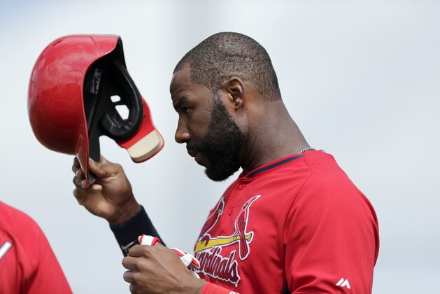 St. Louis Cardinals' Jason Heyward removes his batting helmet during an exhibition spring training baseball game against the Miami Marlins Sunday, March 8, 2015, in Jupiter, Fla. (AP Photo/Jeff Roberson)