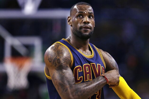 Cleveland Cavaliers forward LeBron James pulls up his sleeve while facing the Boston Celtics in the first quarter of a first-round NBA playoff basketball game in Boston, Thursday, April 23, 2015. (AP Photo/Charles Krupa)