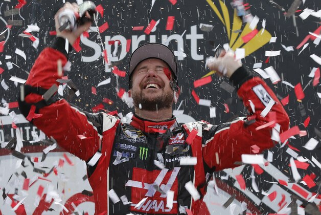 Kurt Busch celebrates after winning the NASCAR Sprint Cup auto race at Richmond International Raceway in Richmond, Va., Sunday, April 26, 2015. (AP Photo/Steve Helber)