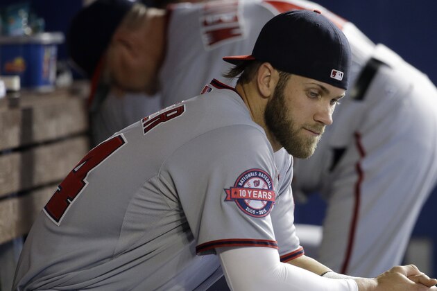 Washington Nationals' Bryce Harper sits in the dugout before baseball game against the Miami Marlins, Sunday, April 26, 2015, in Miami. (AP Photo/Lynne Sladky)