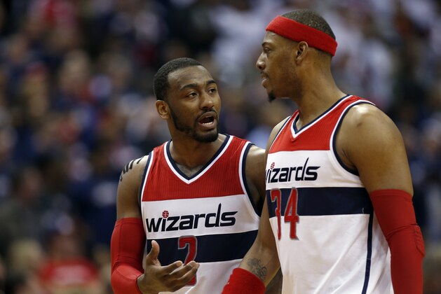 Washington Wizards forward Paul Pierce (34) and Washington Wizards guard John Wall (2) talk in the second half of Game 3 in the first round of the NBA basketball playoffs against the Toronto Raptors, Friday, April 24, 2015, in Washington. The Wizards won 106-99. (AP Photo/Alex Brandon)