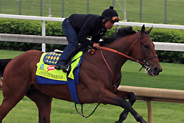 Martin Garcia rides Kentucky Derby hopeful American Pharoah during a morning workout at Churchill Downs in Louisville, Ky., Sunday, April 26, 2015. (AP Photo/Garry Jones)