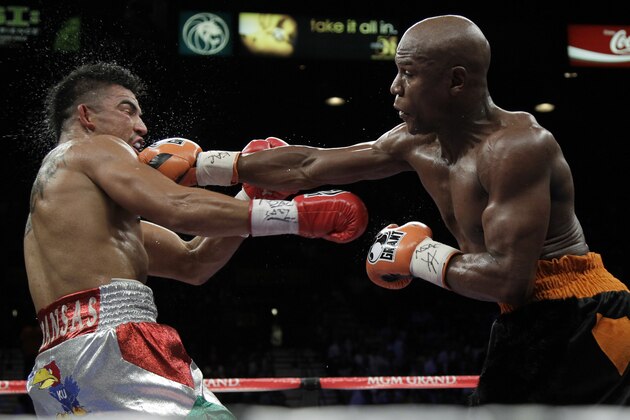 Floyd Mayweather Jr. hits Victor Ortiz Floyd during their WBC welterweight title fight Saturday, Sept. 17, 2011, in Las Vegas. (AP Photo/Julie Jacobson)