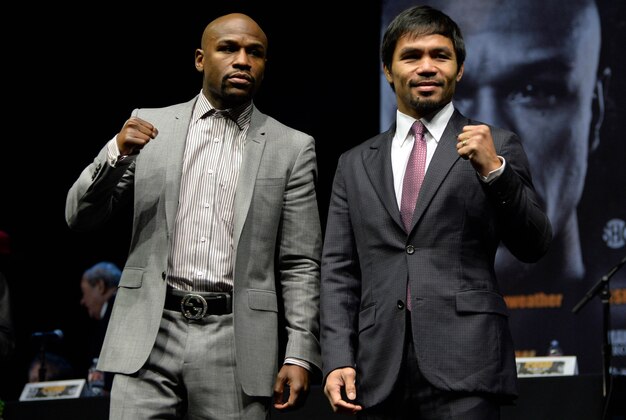 Mar 11, 2015; Los Angeles, CA, USA; Manny Pacquiao poses for photographers during a press conference to announce their fight on May 2, 2015 at the Nokia Theater in Los Angeles. Mandatory Credit: Robert Hanashiro-USA TODAY Sports
