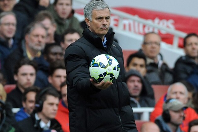 Chelsea manager Jose Mourinho returns match ball to play during the English Premier League soccer match between Arsenal and Chelsea at the Emirates Stadium, London, England, Sunday, April 26, 2015. (AP Photo/Rui Vieira)
