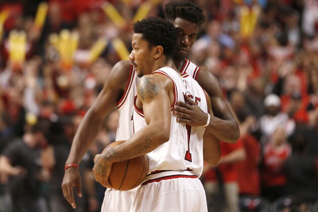 Chicago Bulls guard Derrick Rose (1) hugs Jimmy Butler after Game 2 of the NBA basketball playoffs against the Milwaukee Bucks Monday, April 20, 2015, in Chicago. The Bulls won 91-82. (AP Photo/Charles Rex Arbogast)