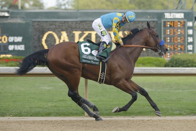 Jockey Victor Espinoza stands up on American Pharoah after winning the $1 million Arkansas Derby horse race at Oaklawn Park in Hot Springs, Ark., Saturday, April 11, 2015. (AP Photo/Danny Johnston)