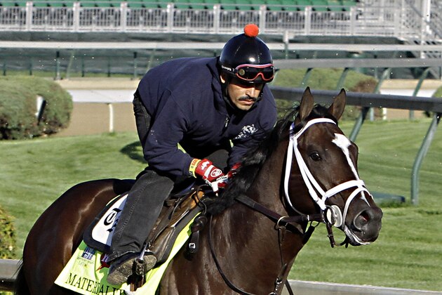 Kentucky Derby hopeful Materiality, with exercise rider Carlos Cano aboard, gallops for trainer Todd Pletcher at Churchill Downs in Louisville, Ky., Thursday, April 23, 2015.  (AP Photo/Garry Jones)