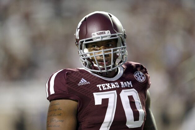 Texas A&M offensive linesman Cedric Ogbuehi prepares to go through drills before an NCAA college football game against Rice Saturday, Sept. 13, 2014, in College Station, Texas. (AP Photo/David J. Phillip)