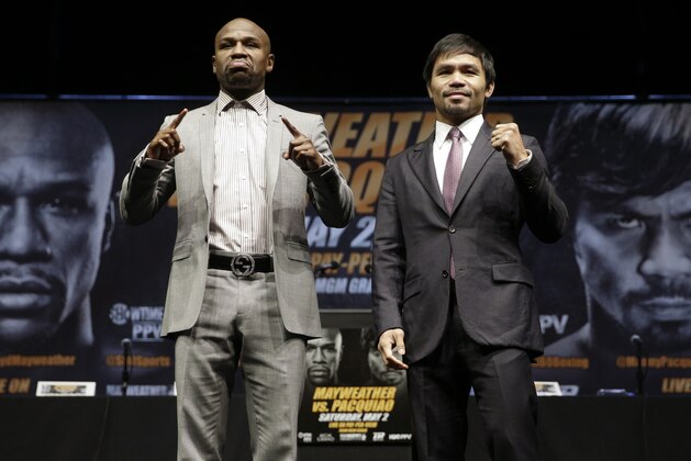 ADVANCE FOR WEEKEND EDITIONS, APRIL 25-26 - FILE - In this March 11, 2015, file photo, boxers Floyd Mayweather Jr., left, and Manny Pacquiao, of the Philippines, pose for photos after a news conference in Los Angeles. This is not Hagler-Hearns or Tyson vs. Anyone. Floyd Mayweather Jr. is the greatest defensive boxer in history, and Manny Pacquiao hasn't shown knockout power in a while. Expect this fight to go to the scorecards. (AP Photo/Jae C. Hong, File)