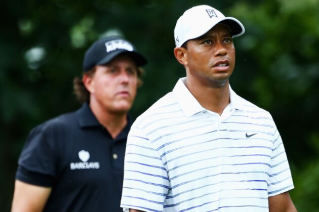LOUISVILLE, KY - AUGUST 08:  Tiger Woods (R) of the United States and Phil Mickelson (L) of the United States walk off the 18th teen during the second round of the 96th PGA Championship at Valhalla Golf Club on August 8, 2014 in Louisville, Kentucky.  (Photo by Andy Lyons/Getty Images)