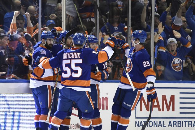 New York Islanders defenseman Johnny Boychuk (55), Nick Leddy (2) center John Tavares (91), center Ryan Strome (18) and center Brock Nelson (29) celebrate Tavares's goal against the Washington Capitals  during the first period in Game 6 in the first round of the NHL hockey Stanley Cup playoffs at Nassau Coliseum on Saturday, April 25, 2015, in Uniondale, N.Y. The Islanders won 3-1 to even the best-of-seven games series at 3-3. (AP Photo/Kathy Kmonicek)