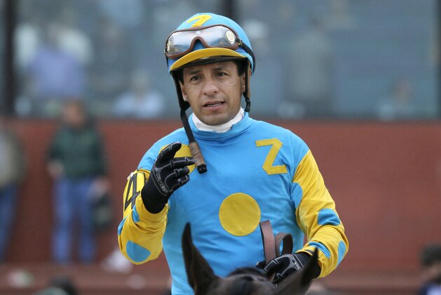 American Pharoah and jockey Victor Espinoza are led to the winners circle after winning the $750,000 Rebel Stakes horse race at Oaklawn Park in Hot Springs, Ark., Saturday, March 14, 2015. (AP Photo/Danny Johnston)