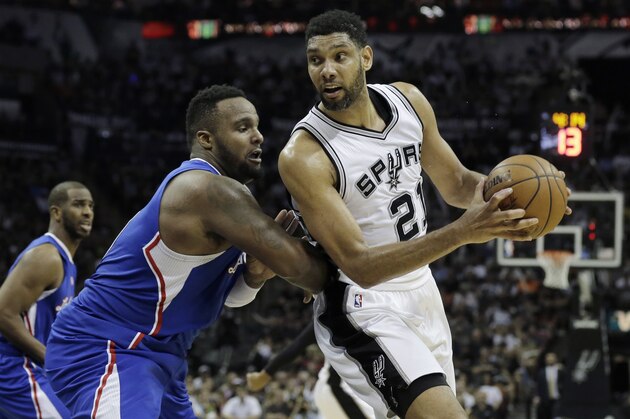 San Antonio Spurs forward Tim Duncan (21) drives around  Los Angeles Clippers forward Glen Davis during the second half of Game 4 in an NBA basketball first-round playoff series, Sunday, April 26, 2015, in San Antonio. Los Angeles won 114-105. (AP Photo/Darren Abate)