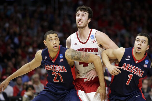 Arizona's Brandon Ashley, left, and Gabe York, right, try to block out Wisconsin forward Frank Kaminsky after a free throw during the second half of a college basketball regional final in the NCAA Tournament, Saturday, March 28, 2015, in Los Angeles. (AP Photo/Jae C. Hong)