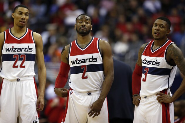 Washington Wizards forward Otto Porter Jr. (22), guard John Wall (2) and guard Bradley Beal (3) stand during a break in the first half of Game 4 in the first round of the NBA basketball playoffs against the Toronto Raptors, Sunday, April 26, 2015, in Washington. (AP Photo/Alex Brandon)