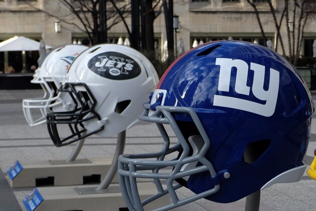 Giant NFL football helmets are displayed in Pioneer Court Wednesday, April 15, 2015, in downtown Chicago, as the city prepares to host the 2015 NFL Draft from April 30 to May 2. (AP Photo/Kiichiro Sato)