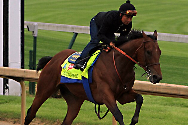 Martin Garcia rides Kentucky Derby hopeful American Pharoah during a morning workout at Churchill Downs in Louisville, Ky., Sunday, April 26, 2015. (AP Photo/Garry Jones)