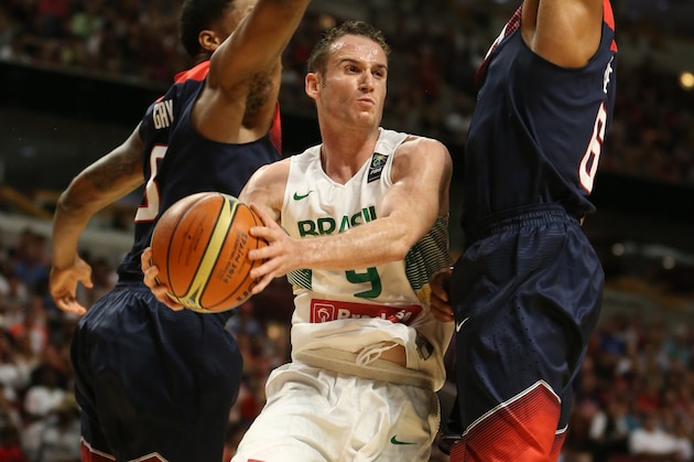 CHICAGO, IL - AUGUST 16: Marcelo Huertas #9 of the Brazil National Team passes against Rudy Gay #8 of the USA Basketball Men's National Team on August 16, 2014 at the United Center in Chicago, Illinois.  NOTE TO USER: User expressly acknowledges and agrees that, by downloading and/or using this Photograph, user is consenting to the terms and conditions of the Getty Images License Agreement. Mandatory Copyright Notice: Copyright 2014 NBAE (Photo by Gary Dineen/NBAE via Getty Images)