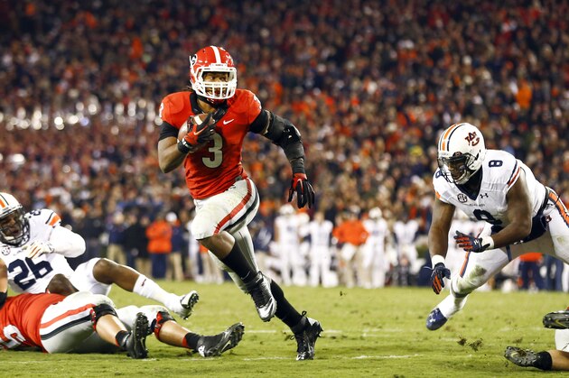 Georgia running back Todd Gurley (3) runs between Auburn linebacker Justin Garrett (26) and Auburn linebacker Cassanova McKinzy (8) to score a touchdown in the second half of an NCAA college football game Saturday, Nov. 15, 2014, in Athens, Ga. (AP Photo/John Bazemore)